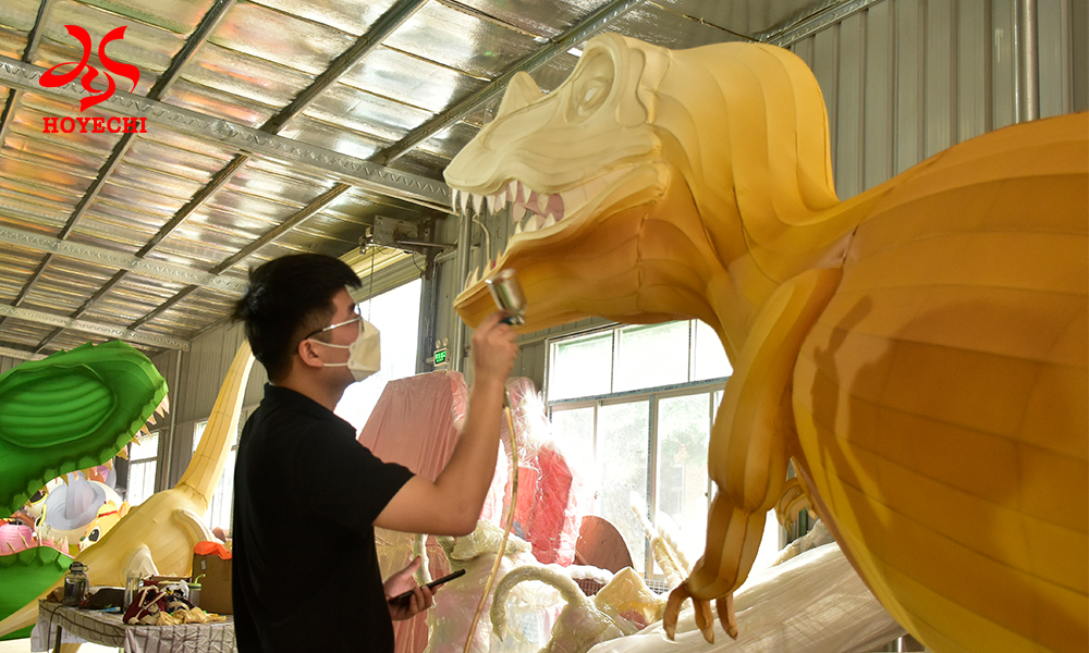 Close-up of a skilled artisan hand-painting the eyes of a custom dragon lantern, showcasing the detailed craftsmanship of HOYECHI traditional Chinese lantern production.