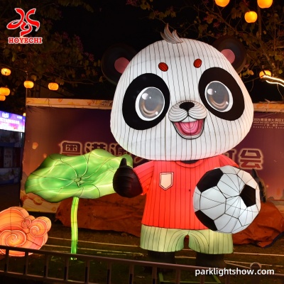 Cartoon panda lantern in a red shirt holding a soccer ball