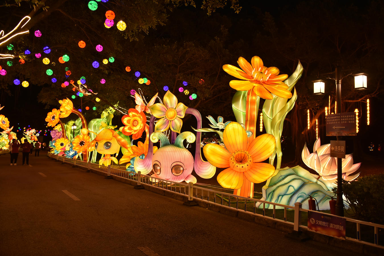 Flower and Botanical Lantern Festival Theme Large illuminated flower lantern displays creating a botanical garden light festival visitor route