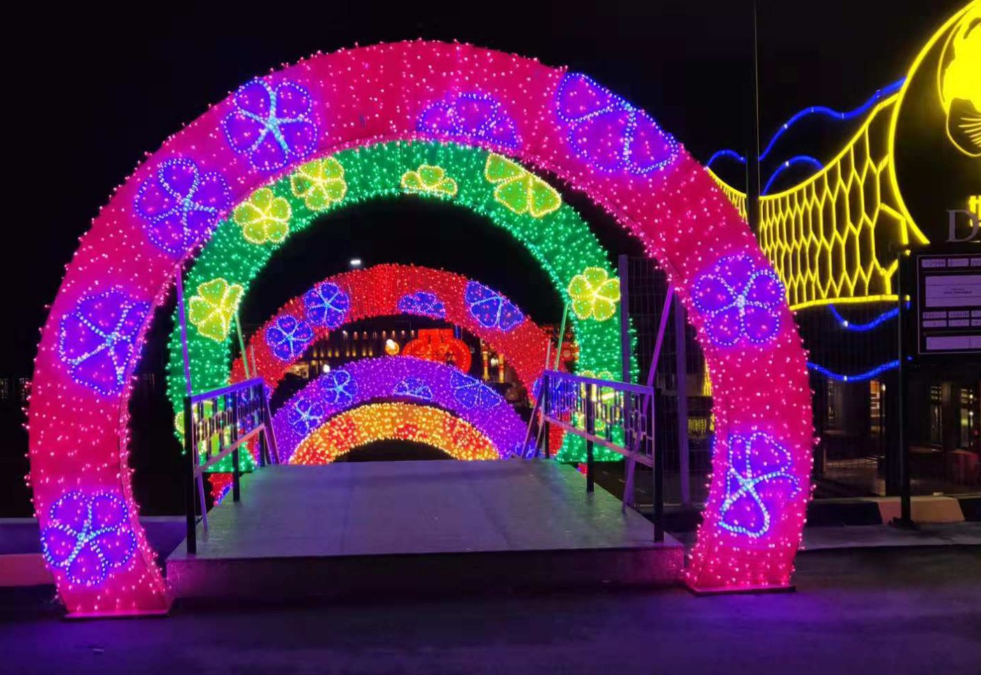 Walk-Through Lantern Tunnel for Visitor Interaction Real colorful walk-through lantern tunnel decoration for visitor interaction at an outdoor light festival