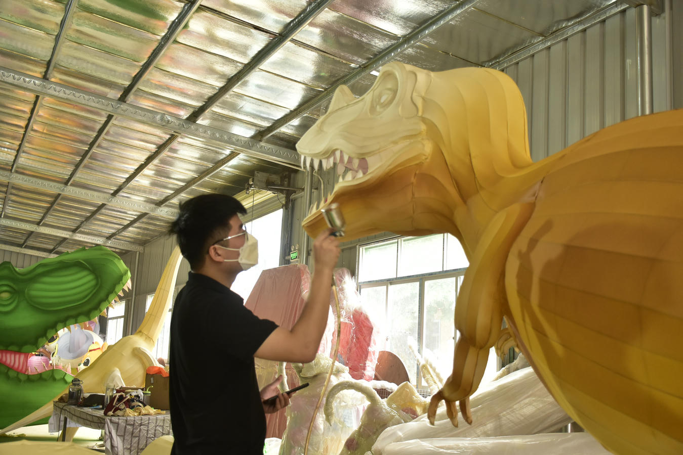 HOYECHI Lantern Festival Factory Pre-Installation HOYECHI team checking a real lantern festival display during factory pre-installation before project delivery