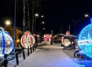 A winter amusement park light show scene in Kazan, Russia, featuring illuminated gift displays, glowing ball light sculptures, snowy pathways, and outdoor lighting decorations designed for cold weather operation.